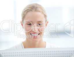 Portrait of a confident businesswoman working at a computer