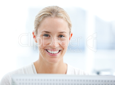 Portrait of a smiling businesswoman working at a computer