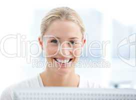 Portrait of a smiling businesswoman working at a computer