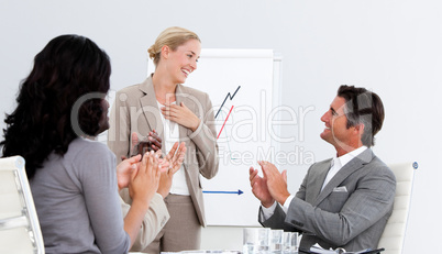 Smiling business people applauding a good presentation