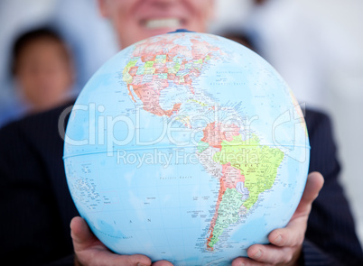 Close-up of a businessman holding a terrestrial globe