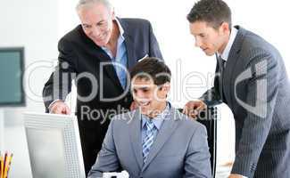 Positive businessmen working at a computer