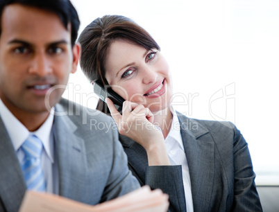 Confident businesswoman on phone sitting on a sofa