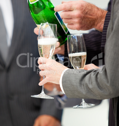Close-up of a business person serving Champagne