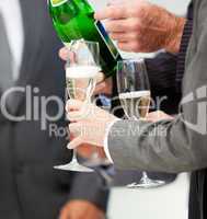 Close-up of a business person serving Champagne