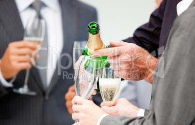 Close-up of a businessman serving Champagne