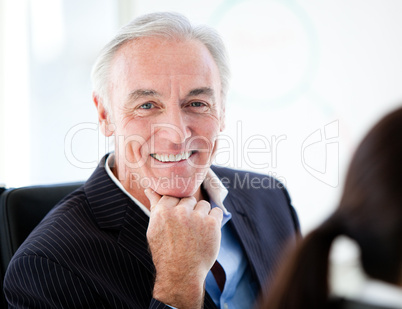 Charismatic senior businessman in a meeting