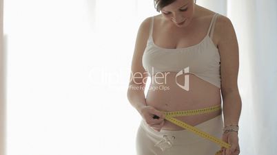 Pregnant woman with measuring tape