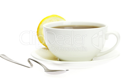 white cup, a spoon and a lemon