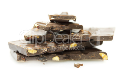 pieces of chocolate with nuts and raisins folded mountain, isolated on white