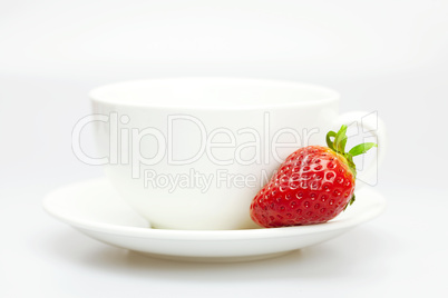 white cup and strawberries isolated on white