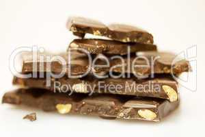 Mount chunks of chocolate with nuts isolated on white