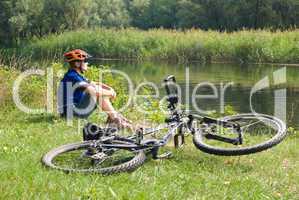 young bicyclist in helmet