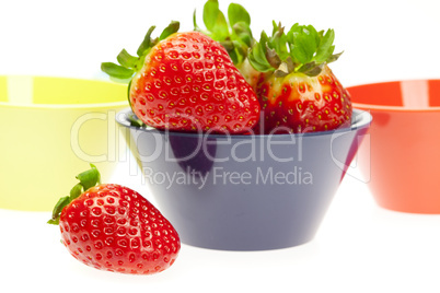 juicy strawberries in a bowl isolated on white