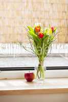 spring bouquet with tulips and an apple