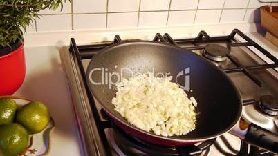 Shaking Onions in Pan