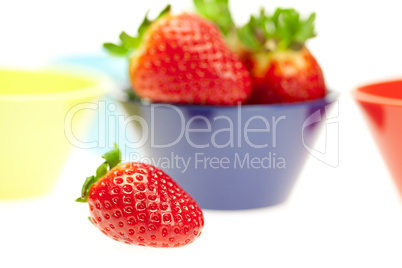 juicy strawberries in a bowl isolated on white