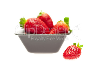 juicy strawberries in a bowl isolated on white