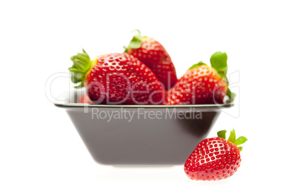 juicy strawberries in a bowl isolated on white