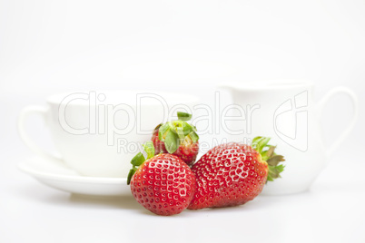 juicy strawberries and tableware isolated on white