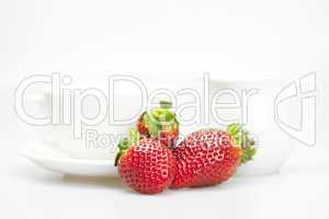 juicy strawberries and tableware isolated on white