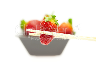 juicy strawberries in a bowl isolated on white