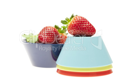 juicy strawberries in a bowl isolated on white