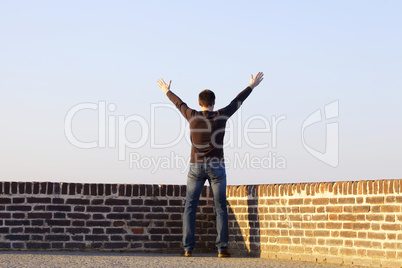 man with outstretched arms standing against the sky man with outstretched arms standing against the sky