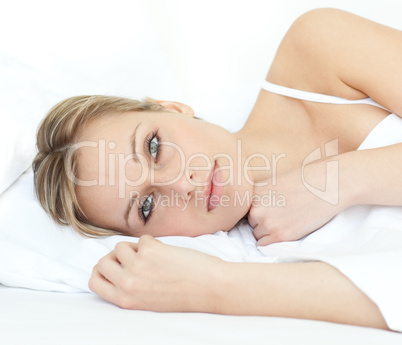 Charming woman relaxing in a bed