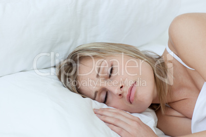 Blond woman sleeping in a bed