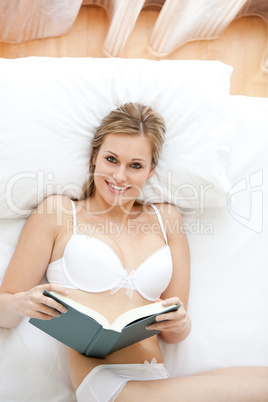 Beautiful woman in underwear reading a book