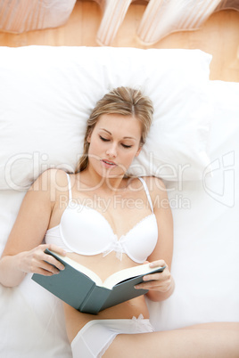 Attractive woman in underwear reading a book