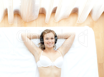Relaxed woman in underwear listening music