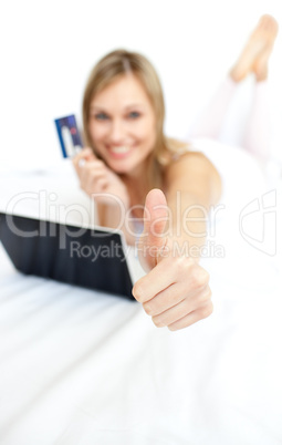 Happy woman with a thumb up shopping on-line