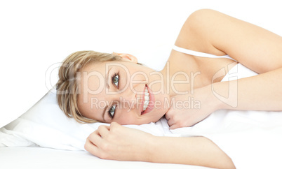 Cheerful woman relaxing lying on a bed