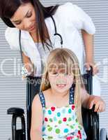 Smiling cute girl sitting on the wheelchair