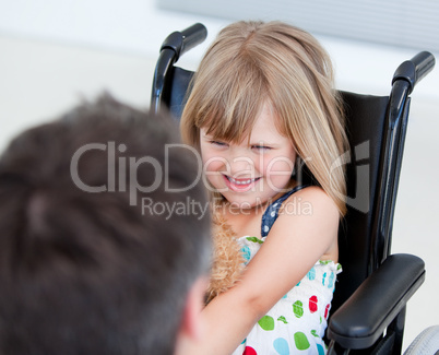 Reserved little girl sitting on the wheelchair