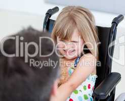 Reserved little girl sitting on the wheelchair