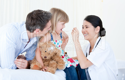 Professional female doctor giving syrup to a nice little girl