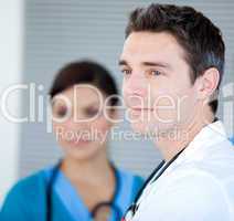 Charismatic male doctor looking at the window