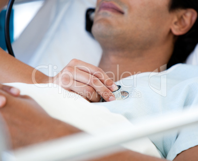 Close-up of a patient examinated by a doctor on a medical bed