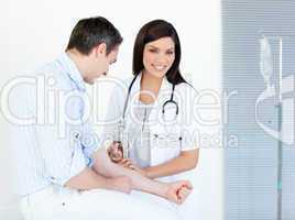 Smiling female doctor making injection to her patient