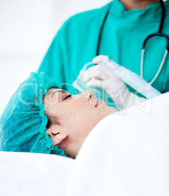 Female patient receiving an oxygen mask