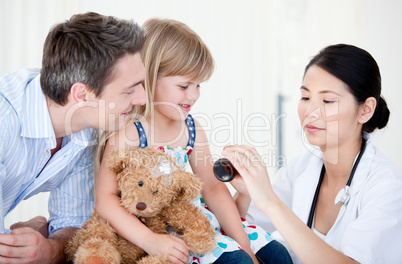 Confident female doctor giving syrup to a little girl
