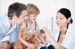 Confident female doctor giving syrup to a little girl