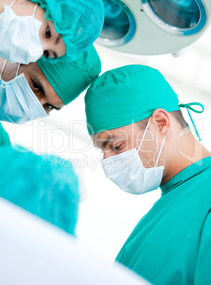 Multi-ethnic madical team working on a patient