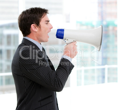 Frustrated businessman yelling through a megaphone