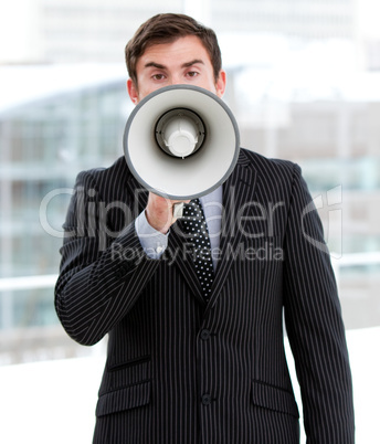 Stressed businessman yelling through a megaphone