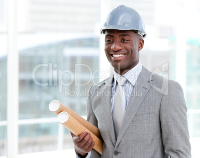 Portrait of a cheerful male architect holding blueprints