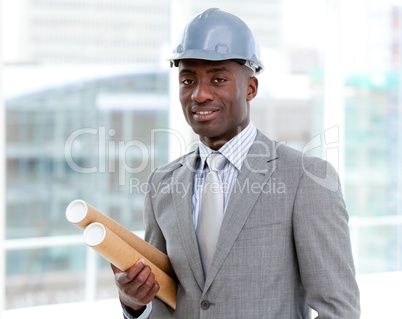 Portrait of a charismatic male architect holding blueprints